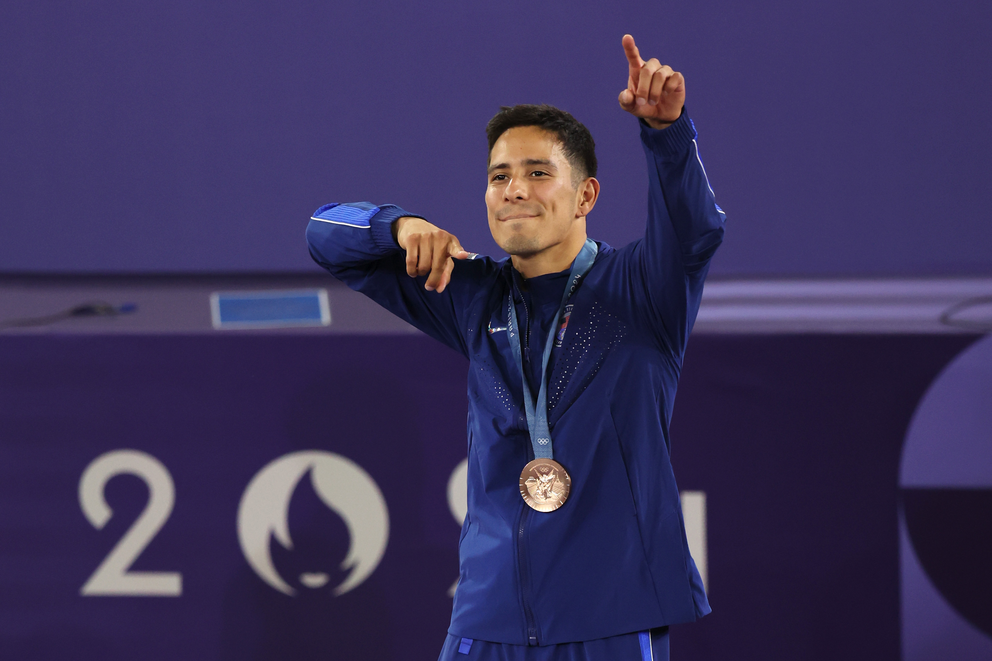 Bronze medalist B-Boy Victor of Team United States celebrates on the podium during the Breaking B-Boys medal ceremony.