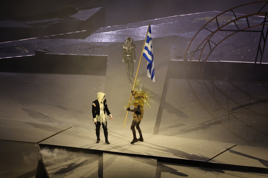 The Horsewoman passes the national flag of Greece to The Golden Voyager