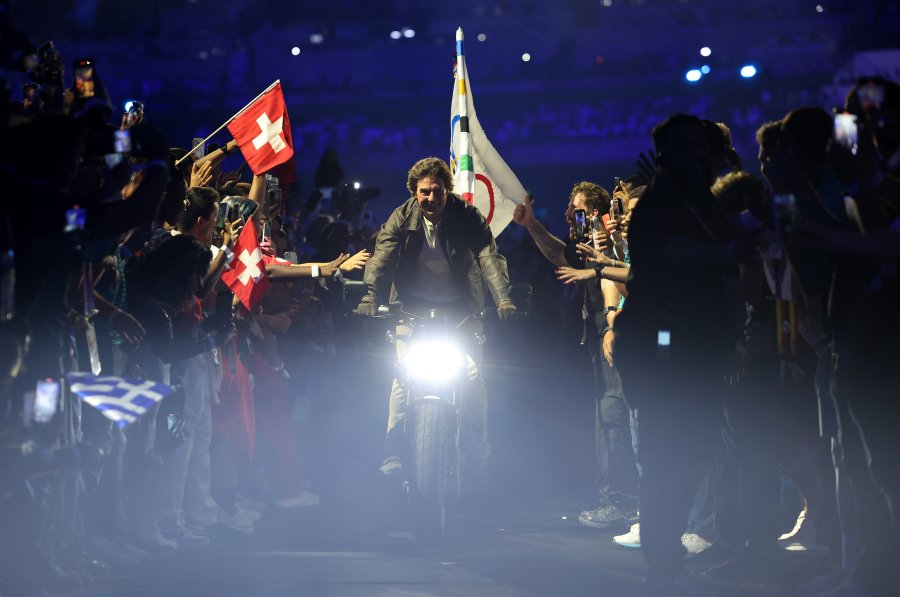 US' gymnasts Simone Biles holds the Olympic flag next to Los Angeles' Mayor Karen Bass