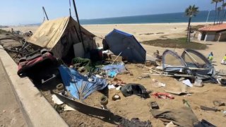 City crews clear a homeless encampment from Dockweiler State Beach Thursday Aug. 22, 2024.