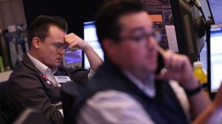 Traders work on the floor of the New York Stock Exchange during morning trading in New York City.