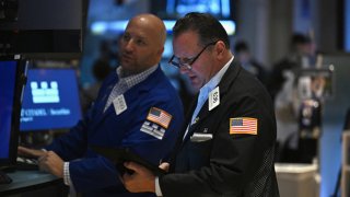 Traders work on the floor of the New York Stock Exchange (NYSE) during morning trading in New York on August 23, 2024.