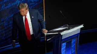 Former US President and Republican presidential candidate Donald Trump walks away during a commercial break as US Vice President and Democratic presidential candidate Kamala Harris take notes during a presidential debate at the National Constitution Center in Philadelphia, Pennsylvania, on September 10, 2024. 