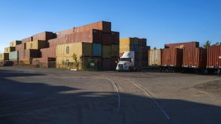 Shipping containers stacked at a storage yard outside of the APM Terminals yard at the Port of Mobile in Mobile, Alabama, US, on Saturday, Sept. 28, 2024.