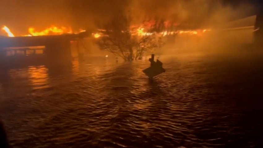 buildings on fire in flood water