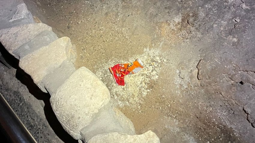 This undated photo provided by Carlsbad Caverns National Park shows a bag of Cheetos that was dropped off trail by a visitor in the Big Room at the national park near Carlsbad, N.M.