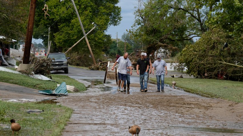 People walk along River St.