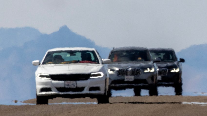 FURNACE CREEK, CALIFORNIA – JULY 16: Cars shimmer in the heat haze as the temperature rises past about 127 degrees Fahrenheit on a day that could set a new world heat record in Death Valley National Park on July 16, 2023 near Furnace Creek, California. Weather forecasts for tomorrow call for a high temperature of 129 degrees Fahrenheit and possibly as high as 131.  Previously, the highest temperature reliably recorded on Earth was 129.2 F (54C) in Death Valley in 2013. A century earlier, a high temperature in Death Valley reportedly reached 134 F but many modern weather experts have rejected that claim along with other high summer temperatures reported in the region that year.  (Photo by David McNew/Getty Images)