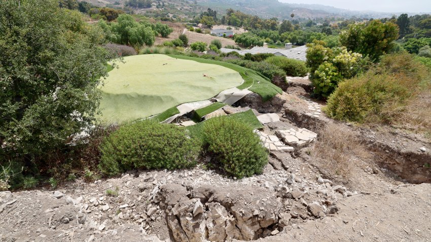 Rancho Palos Verdes, CA - August 01: A view of a large fissure that has opened up since February, damaging a Portuguese Bend home and putting green after last winter's heavy rain in Rancho Palos Verdes Thursday, Aug. 1, 2024. Due to continual land movement, the Portuguese bend neighborhood in Rancho Palos Verde could face power shut off. Mike Hong, whose home neighbors a large fissure that has been getting larger and deeper since February, when the area was inundated with heavy rains. He says that water is draining from Rolling Hills homes into Altamira Canyon and directly flowing into the earth and not into the ocean, which is part of a proposed drainage plan. He says lining the canyon would help as rain saturation is one of the contributing factors to movement in the area. The fissure also passes through and through the Palos Verdes Nature Preserve. (Allen J. Schaben / Los Angeles Times via Getty Images)