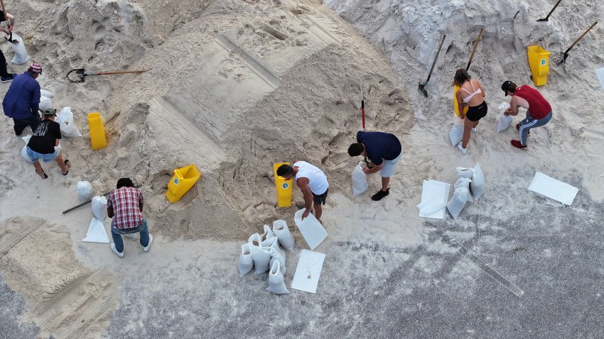 In this aerial view, people fill sandbags at Helen Howarth Park.