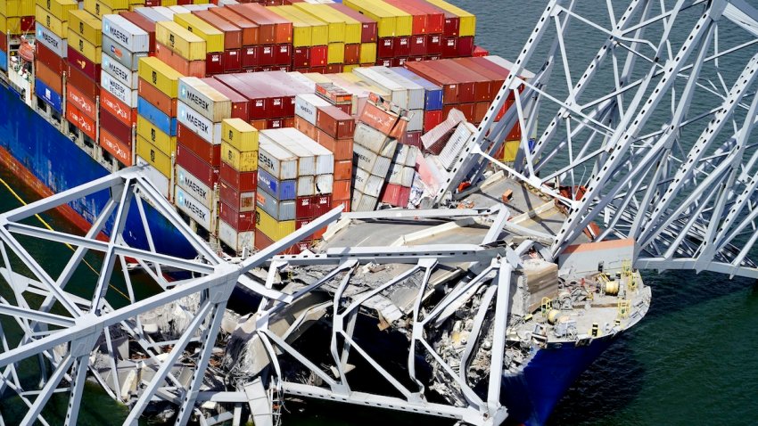 FILE – In this aerial image released by the Maryland National Guard, the cargo ship Dali is stuck under part of the structure of the Francis Scott Key Bridge after the ship hit the bridge, March 26, 2024, in Baltimore. (Maryland National Guard via AP, File)