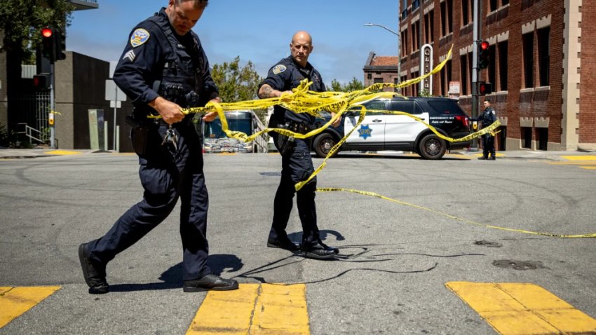 San Francisco Police Department officers remove tape at the scene of a shooting on Aug. 21.