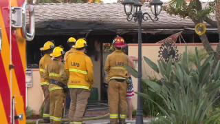 Firefighters respond to a destructive fire that destroyed a home in Reseda on Monday, Sept. 2, 2024.