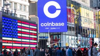 Monitors display Coinbase signage during the company’s initial public offering (IPO) at the Nasdaq MarketSite in New York, on Wednesday, April 14, 2021.