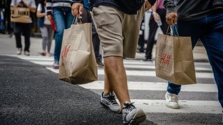 Shoppers carry retail bags along the Magnificent Mile shopping district in Chicago, Illinois, on Tuesday, Aug. 15, 2023.