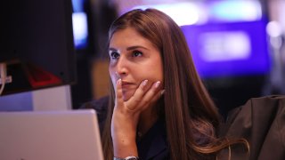 A trader works on the floor of the New York Stock Exchange during morning trading on Aug. 23, 2024.