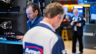 Traders work on the floor of the New York Stock Exchange. 