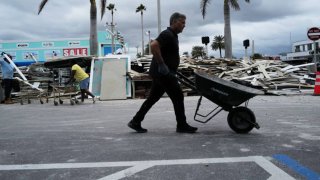 People continue to clean up from the previous storm as preparations are made for Hurricane Milton’s arrival on October 07, 2024, in Treasure Island, Florida.