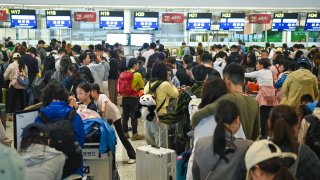 Passengers line up to check in at Chengdu Tianfu International Airport on October 6, 2024 as China’s week-long National Day holiday draws to a close.