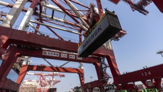 A shipping container and gantry cranes at the Yangshan Deepwater Port in Shanghai, China, on Thursday, Oct. 10, 2024.