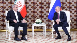 In this pool photograph distributed by the Russian state agency Sputnik, Russia’s President Vladimir Putin meets with Iran’s President Masoud Pezeshkian on the sidelines of an international forum “Interrelation of times and civilizations – basis of peace and development” dedicated to the 300th anniversary of poet Magtymguly Fragi’s birthday in Ashgabat on October 11, 2024. 