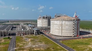 This aerial photograph shows the two Liquified Natural Gas (LNG) storage tanks at the Dhamra LNG Terminal Private Limited (DLTPL) near Dhamra port in Bhadrak district of India’s Odisha state on October 16, 2024.