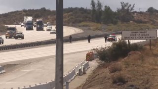 Officers at the scene of a shooting on the 15 Freeway in Hesperia Monday Oct. 18, 2024.