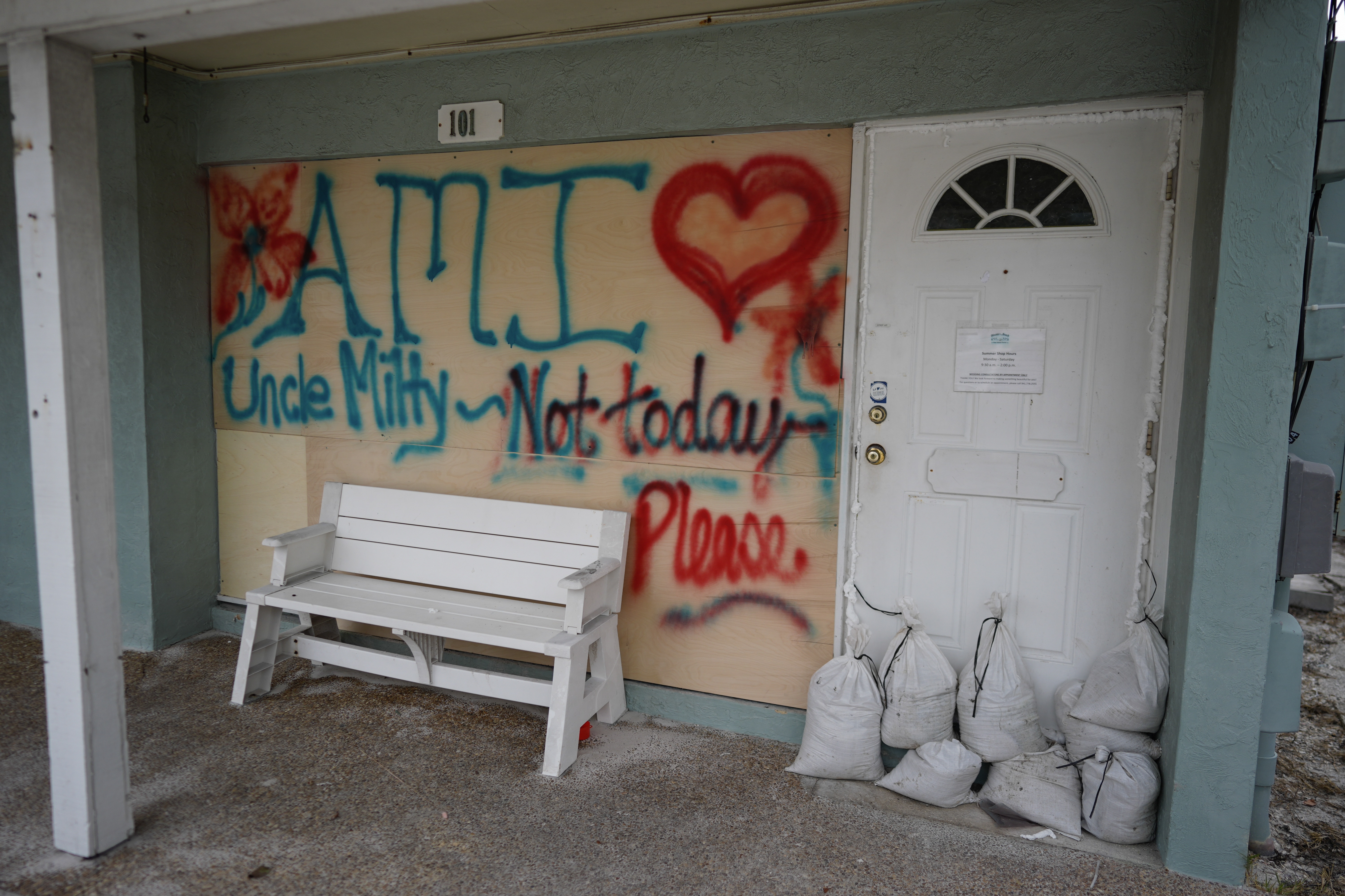 Boards on the window of a store display a message ahead of the arrival of Hurricane Milton, in Bradenton Beach on Anna Maria Island, Florida, Tuesday, Oct. 8, 2024.