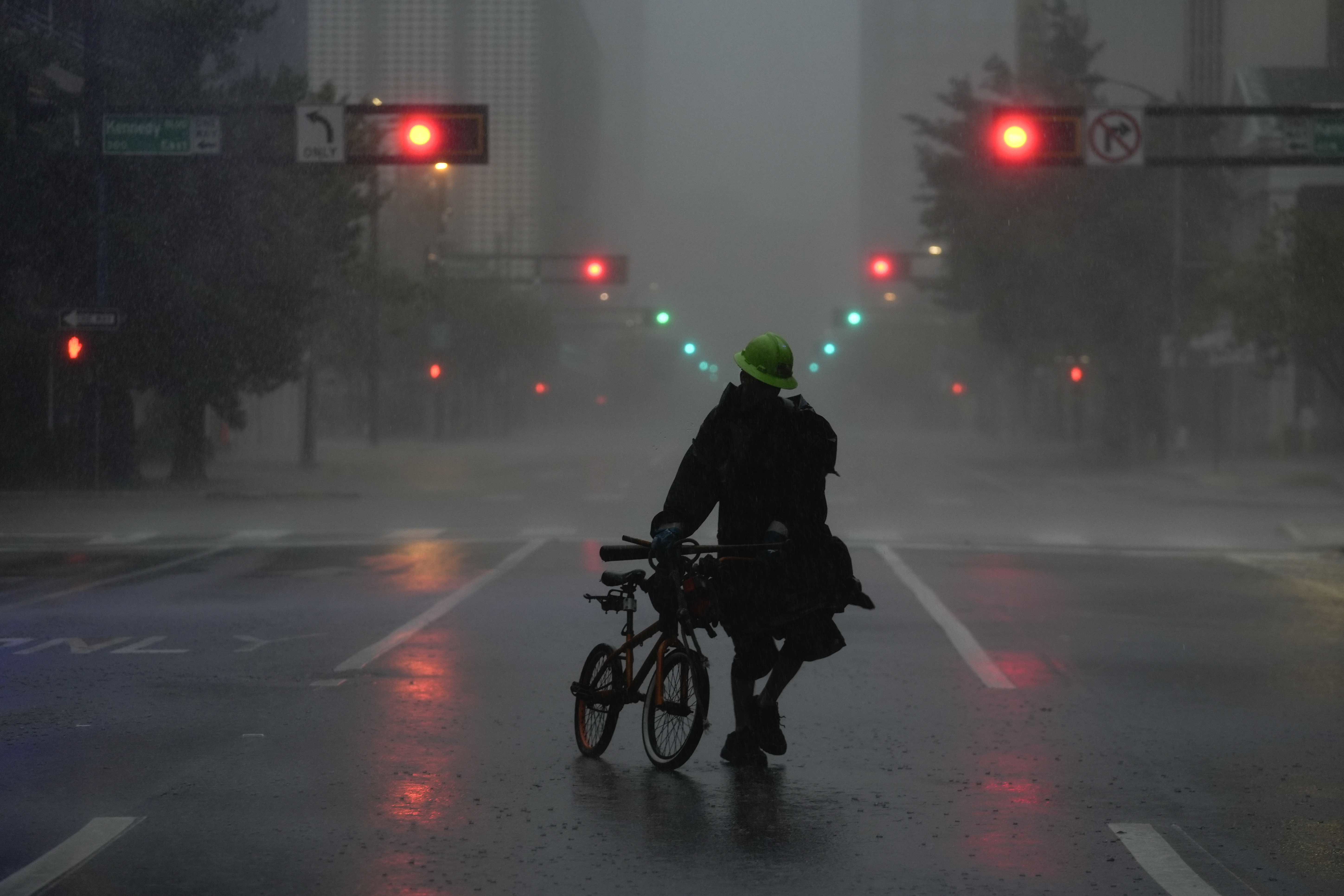 Ron Rook, who said he was looking for people in need of help or debris to clear, walks through windy and rainy conditions on a deserted street in downtown Tampa, Florida, during the approach of Hurricane Milton, Wednesday, Oct. 9, 2024.