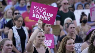 Abortion-rights protesters cheer at a rally