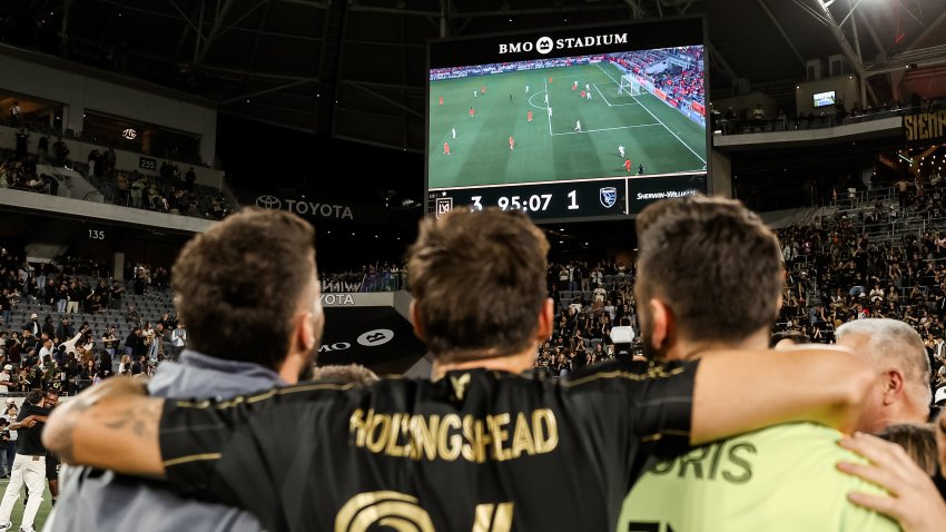 LAFC defender Ryan Hollingshead #24 watches LA Galaxy vs Houston on the video board at BMO Stadium.