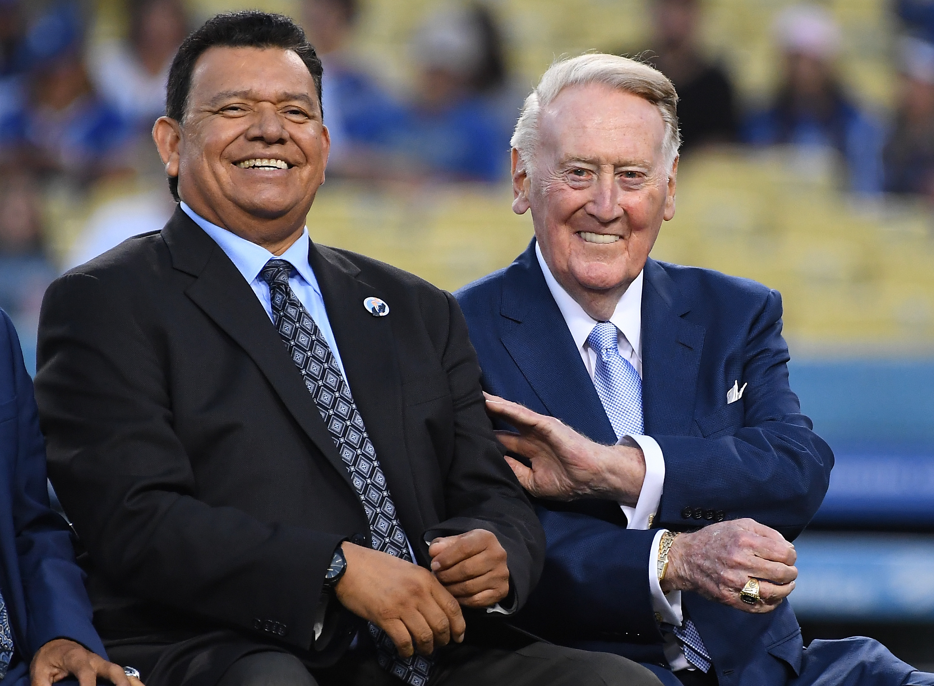 LOS ANGELES, CA – SEPTEMBER 21:  Retired Los Angeles Dodgers broadcaster Vin Scully, left, jokes with Spanish language broadcaster Fernando Valenzuela duirng a pregame ceremony inducting veteran Spanish language broadcaster Jaime Jarrin into the Dodger Stadium Ring of Honor at Dodger Stadium on September 2, 2018 in Los Angeles, California.  (Photo by Jayne Kamin-Oncea/Getty Images)