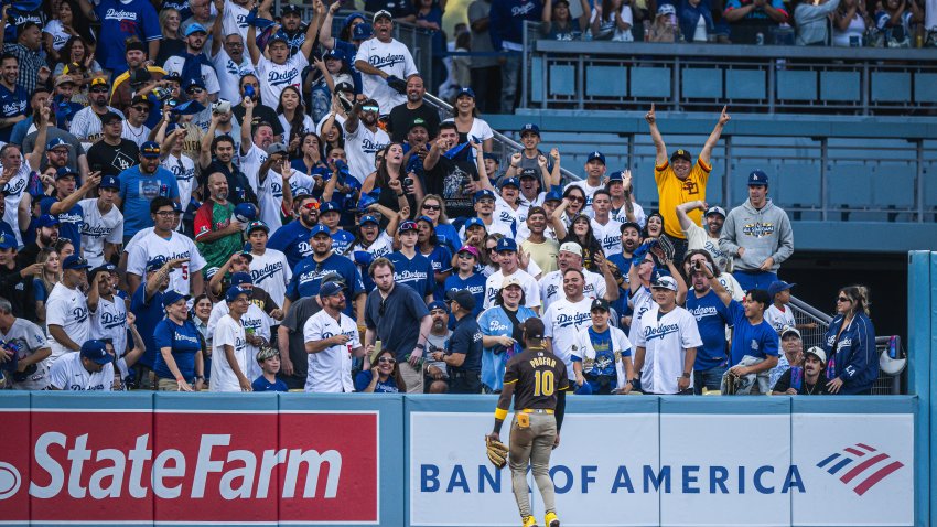 LOS ANGELES, CALIFORNIA – OCTOBER 6: Jurickson Profar #10 of the San Diego Padres celebrates after making a jumping catch into the crowd to rob a home run in the first inning during game two of the National League Divisional Series against the Los Angeles Dodgers at Dodger Stadium on October 6, 2024, in Los Angeles, California. (Photo by Matt Thomas/San Diego Padres/Getty Images)