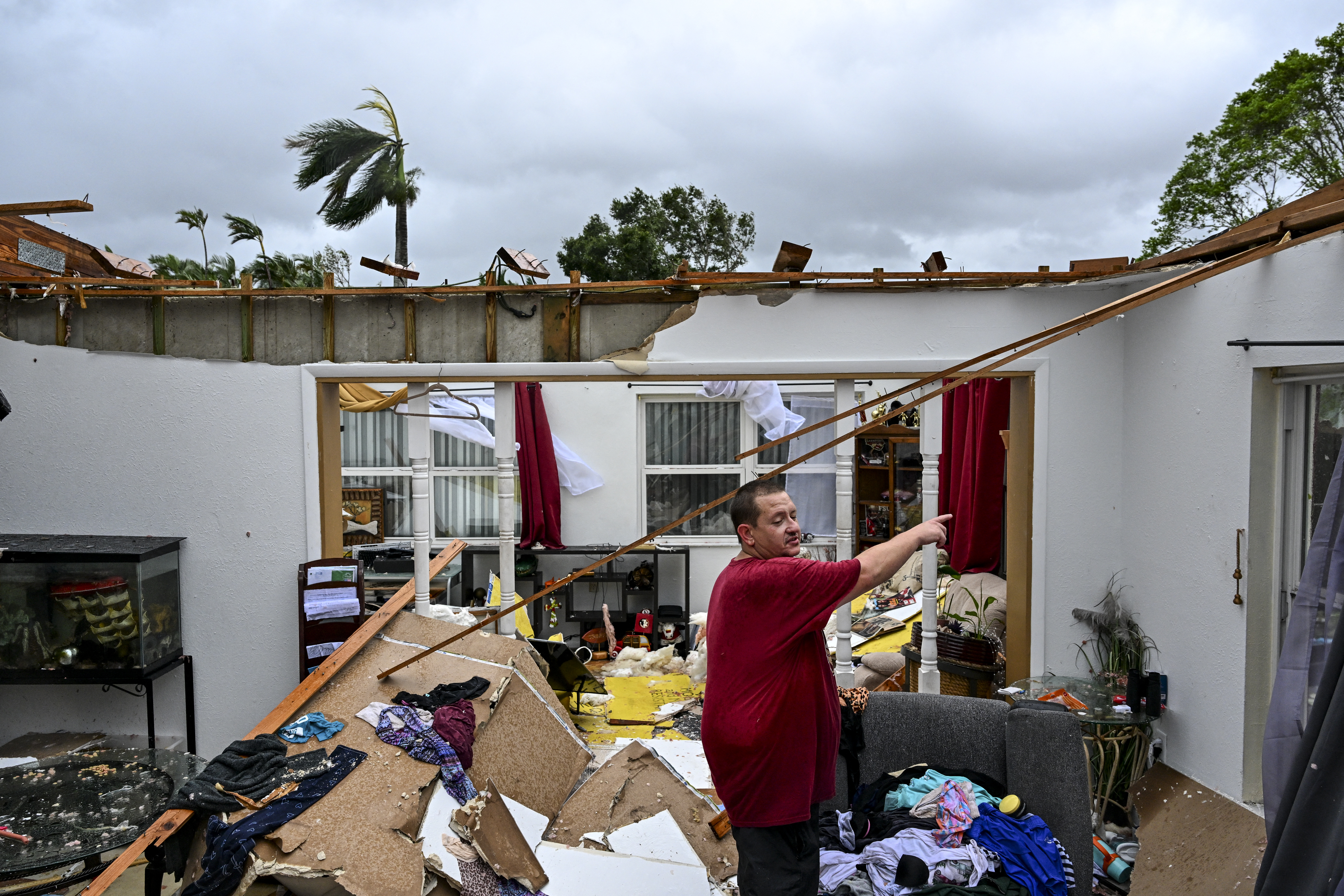 Robert Haight looks around his destroyed house after it was hit by a reported tornado in Fort Myers, Florida, on October 9, 2024, as Hurricane Milton approaches.