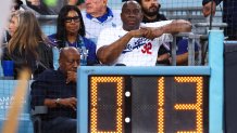 LOS ANGELES, CALIFORNIA - OCTOBER 25: Cookie Johnson and Magic Johnson look on during Game One of the 2024 World Series between the Los Angeles Dodgers and the New York Yankees at Dodger Stadium on October 25, 2024 in Los Angeles, California. (Photo by Maddie Meyer/Getty Images)