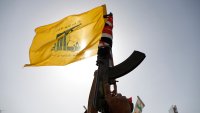 FILE - A Houthi supporter raises a Hezbollah flag during an anti-Israel and anti-U.S. rally in Sanaa, Yemen, Friday, Sept. 27, 2024.