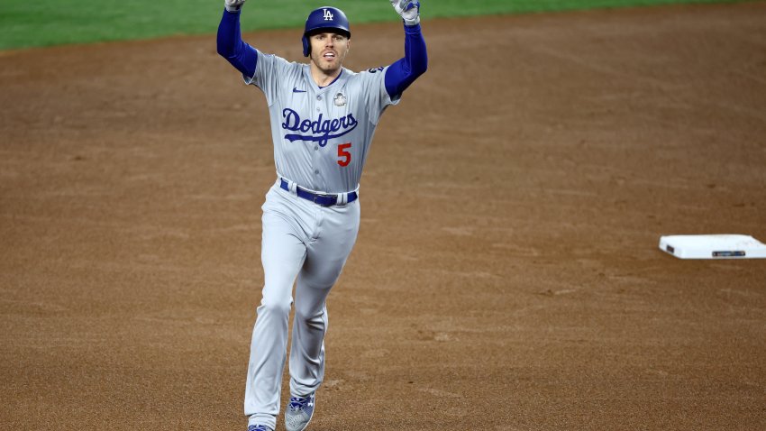 Oct 28, 2024; New York, New York, USA; Los Angeles Dodgers first baseman Freddie Freeman (5) celebrates after hitting a two-run home run during the first inning in game three of the 2024 MLB World Series against the New York Yankees at Yankee Stadium. Mandatory Credit: Vincent Carchietta-Imagn Images