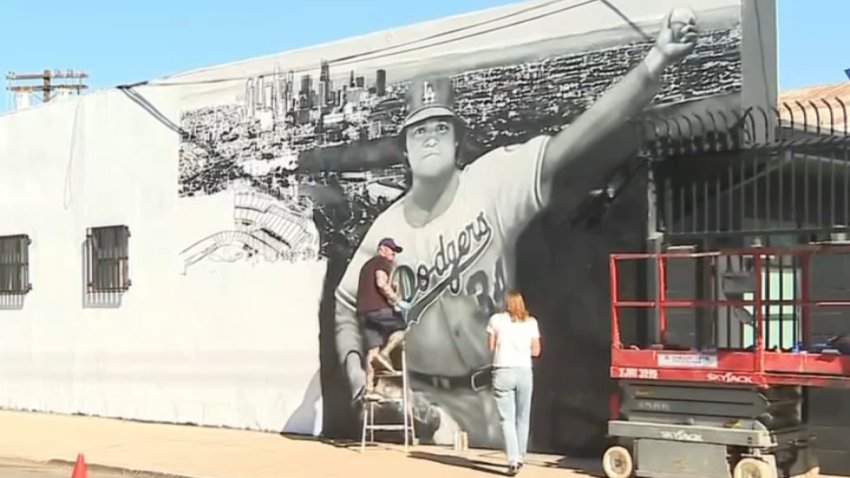 Artist Jonas Never works on a mural of Dodgers icon Fernando Valenzuela in Frogtown on Wednesday, Oct. 23, 2024.