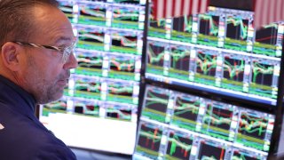 Traders work on the floor of the New York Stock Exchange during morning trading on Oct. 8, 2024.