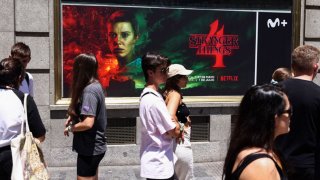 People wait in a line to enter “The Lab,” a “Stranger Things” Netflix series experience in Madrid on June 2, 2022.