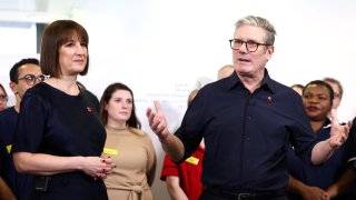 Britain’s Prime Minister Keir Starmer (R) and Britain’s Chancellor of the Exchequer Rachel Reeves (L) speak with members of staff during a visit to University Hospital Coventry and Warwickshire, in Coventry, central England, on October 31, 2024.