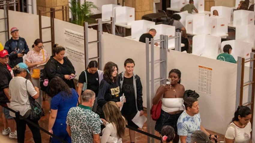 People stand in line at Honolulu Hale to cast their ballot to vote in this year’s general election in Honolulu, Hawaii, on November 5, 2024. 