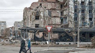 Local residents walk past destroyed houses in the city, approximately 10 km from the frontline, on November 16, 2024 in Pokrovsk, Ukraine.