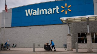 A Walmart sign is displayed outside a Supercenter on November 18, 2024 in Miami, Florida. 