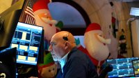 A trader works on the floor of the New York Stock Exchange (NYSE) at the opening bell on November 26, 2024, in New York City. 