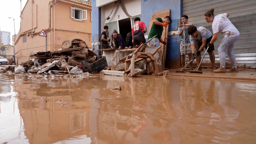 Residents clean their house affected by floods in Valencia, Spain.