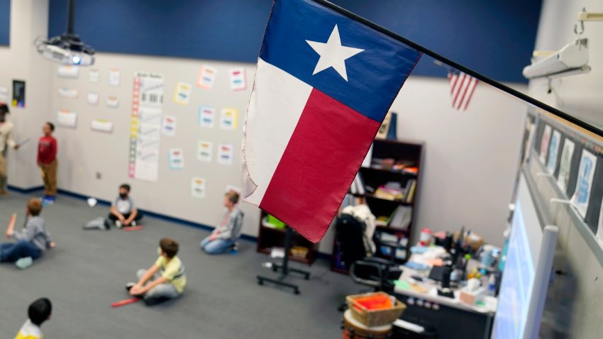 FILE – A Texas flag is displayed in an elementary school in Murphy, Texas, Thursday, Dec. 3, 2020.