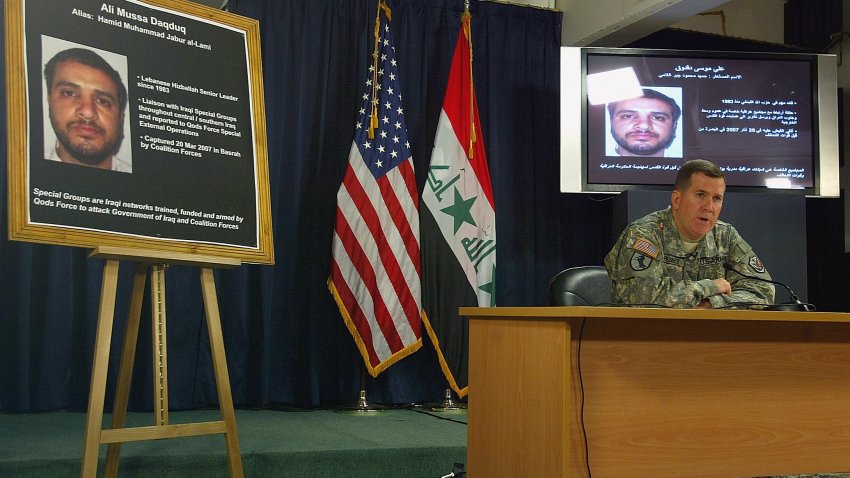 Brig. Gen. Kevin J. Bergner, Multi-National Force-Iraq spokesman talks to the media 02 July  2007 as a picutre of Ali Mussa Daqduq is displayed on a board and on a giant screen at the heavily fortified Green Zone area in Baghdad. US-led forces arrested an Iranian-controlled Lebanese Hezbollah agent in Iraq, where he was training Iraqi extremists, Bergner told reporters today. Bergner said Ali Mussa Daqduq, also known as Hamid Mohammed Jabur al-Lami, was a senior figure in the Lebanese militant group and had come to Iraq on behalf of Iran’s covert Qods Force.