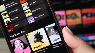 the Spotify music app is seen on a phone