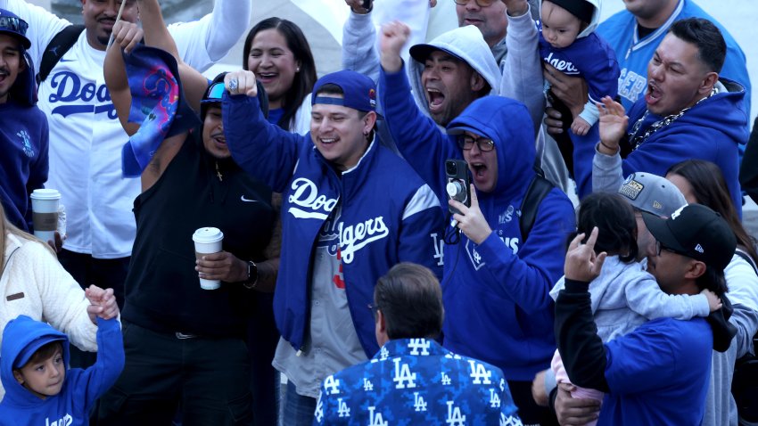 LOS ANGELES, CA – NOVEMBER 1, 2024 – – Fans get into the spirit in the early morning, hours before the Los Angeles Dodgers celebrate their World Series win traveling in a parade route along 5th Street in downtown Los Angeles on November 1, 2024. (Genaro Molina/Los Angeles Times via Getty Images)